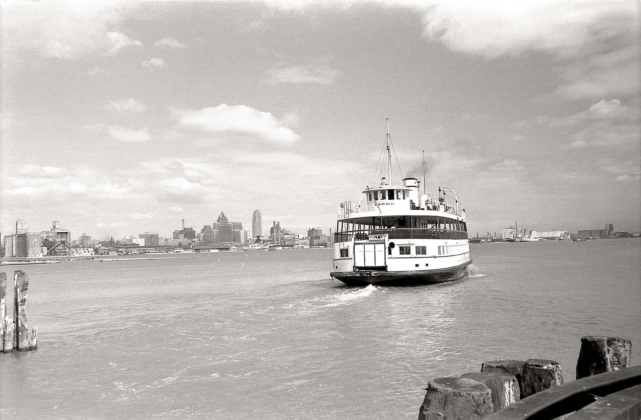 The ferry Sam McBride, running a ‘belt line’ route, departing the Hanlan’s Point ferry dock, 1960.