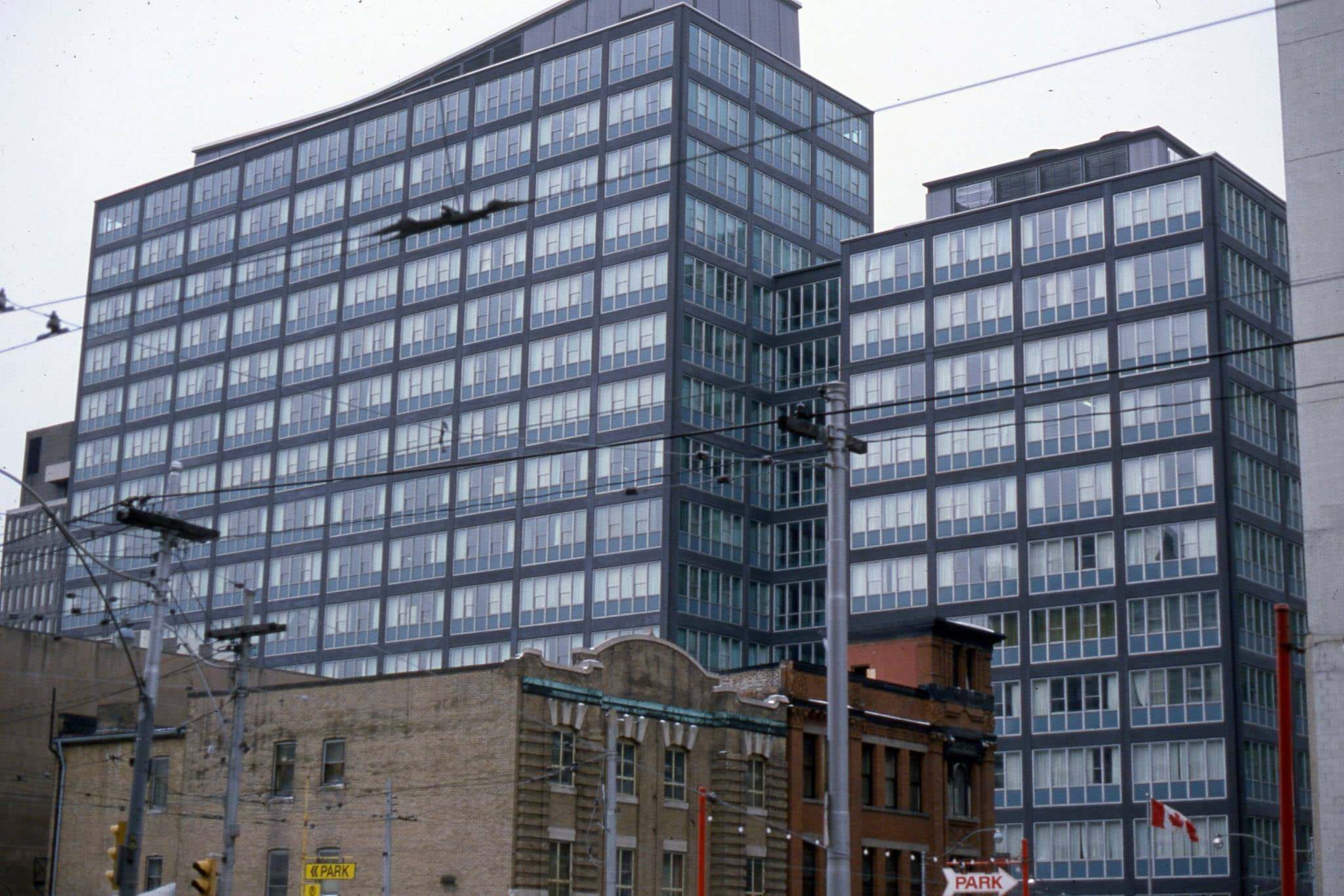 View looking south east from Victoria St., to Lombard Ave. The grey building in the background is 30 Adelaide St. E., 1982