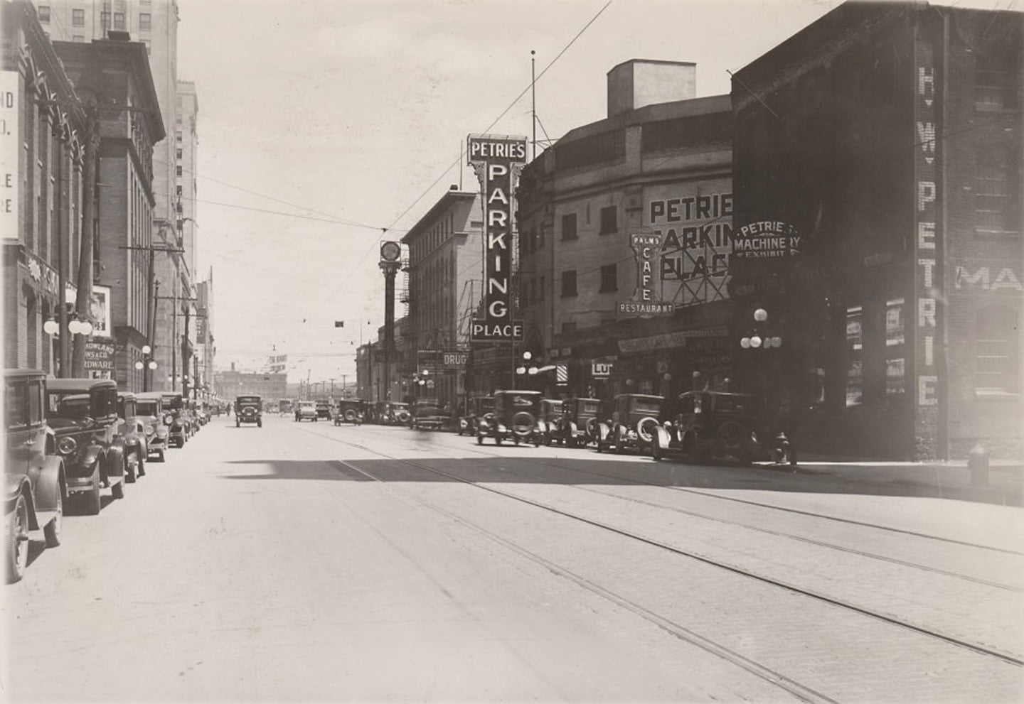 New sign for Petrie's Parking Place, 1929. The main part of the building, now converted into a parking garage, was built in 1887 as the Cyclorama. View is looking east on Front St. West from Simcoe St.