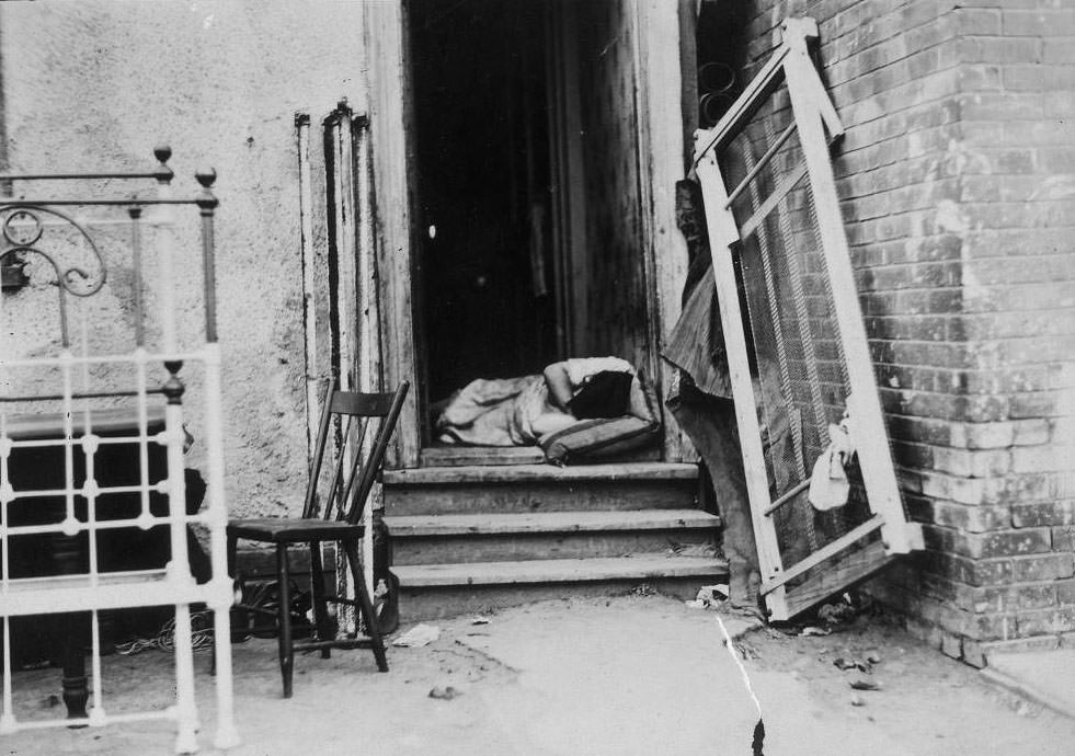Sleeping in doorway on a hot summer night, The Ward, 1910.