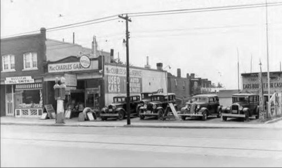 MacCharles garage, used cars sales, and auto repairs and parts. Station opened in December, 1929. Located at 1901 Danforth. Note used cars for sale in lot, 1945