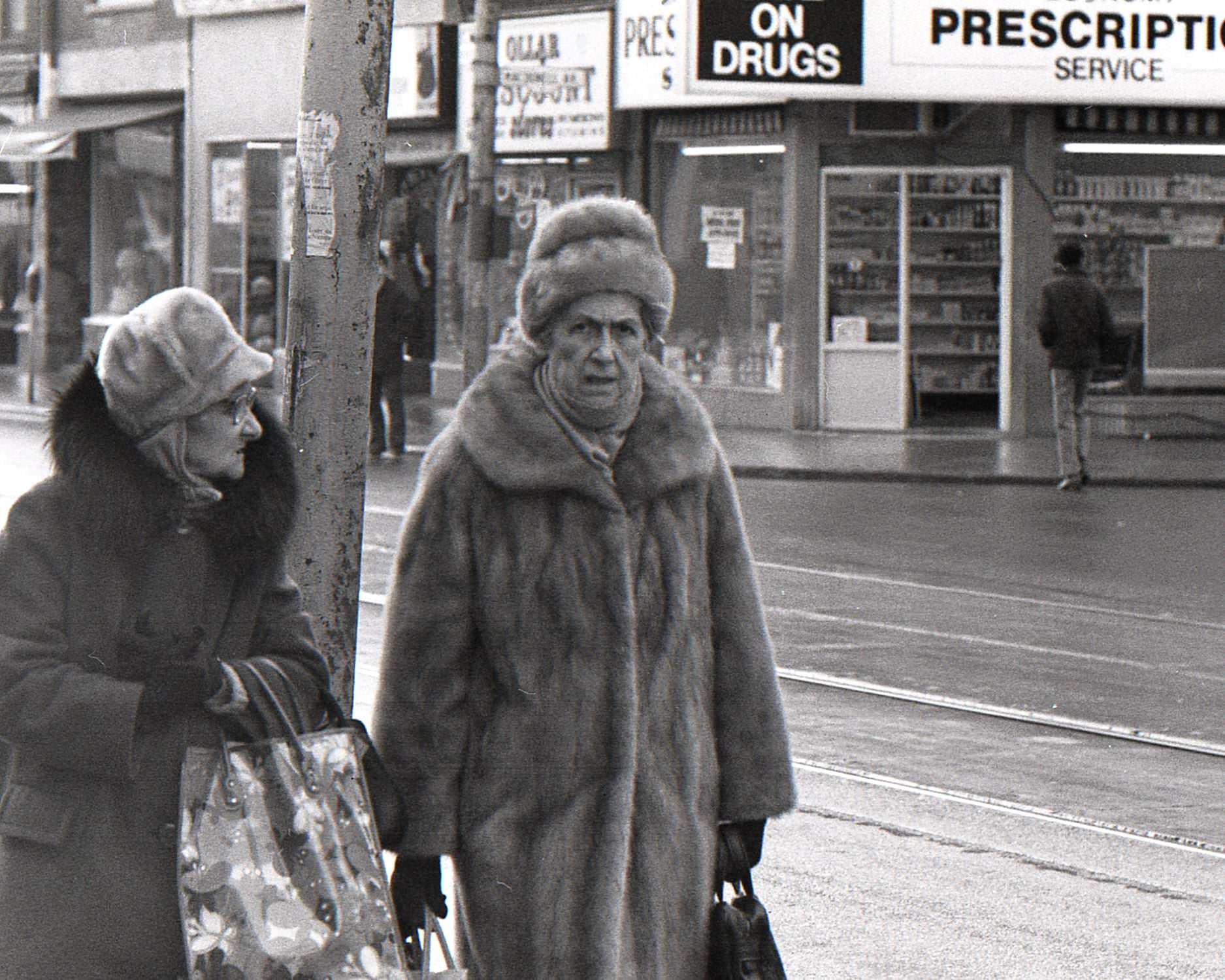 An old parking meter and the newspaper box on Queen St. W. near Jameson Ave, 970s