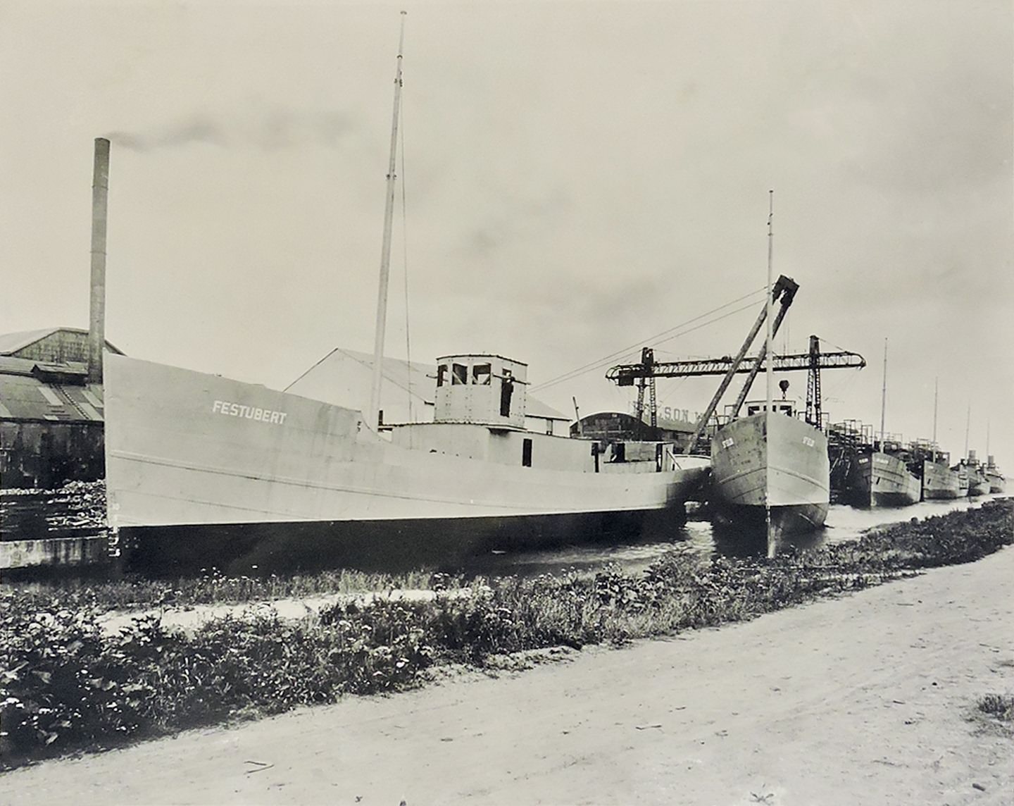 Polson Iron Works Shipyard in Toronto, 1917. View shows six mine sweepers being fitted out for use in WWI, including the Festubert, St. Eloi, St. Julien, Vimy, Ypres and Messines.