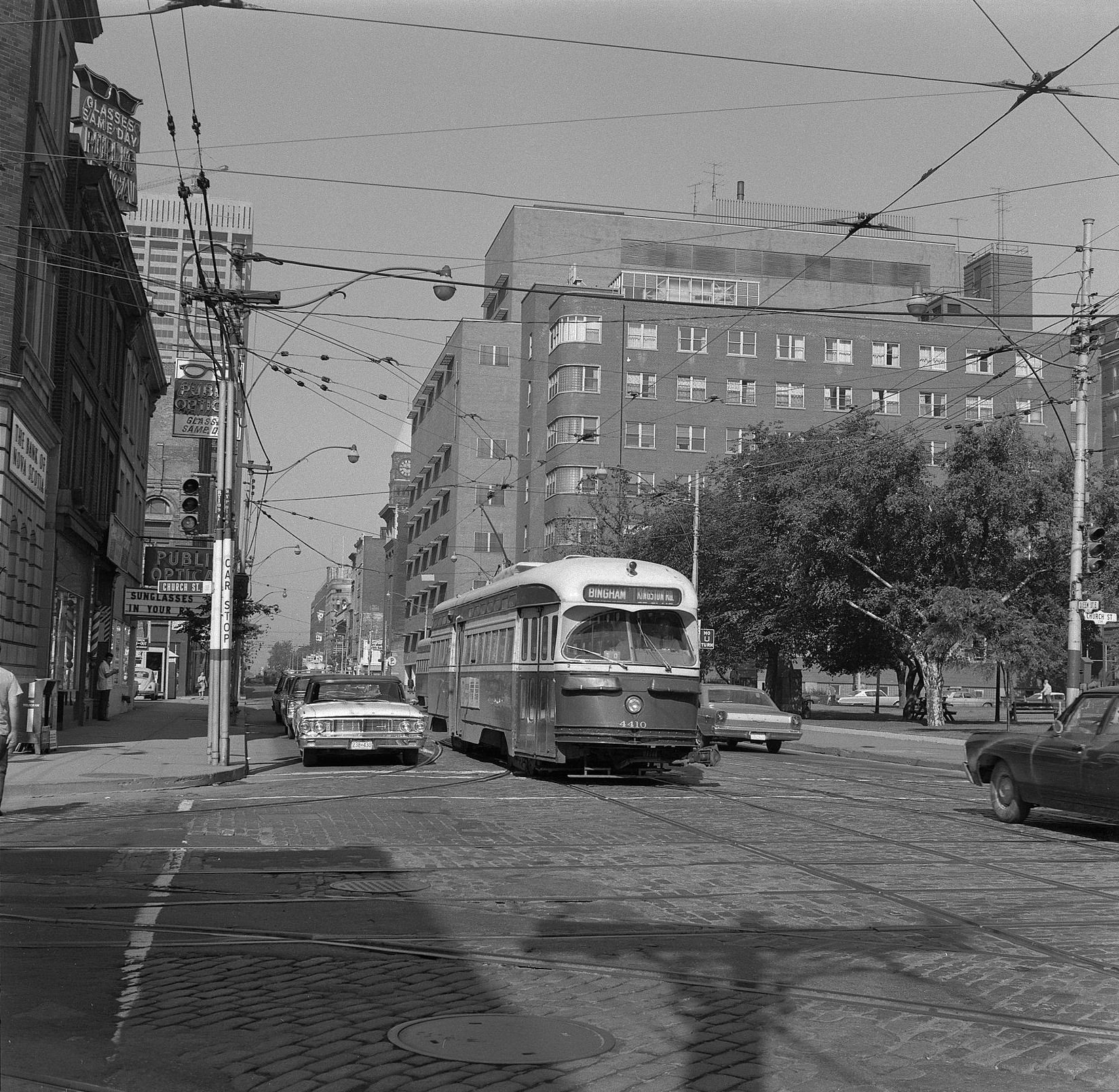 TTC Streetcar 4410 Kingston Road line travelling eastbound on Queen Street East at Church Street. 4 July 1968.