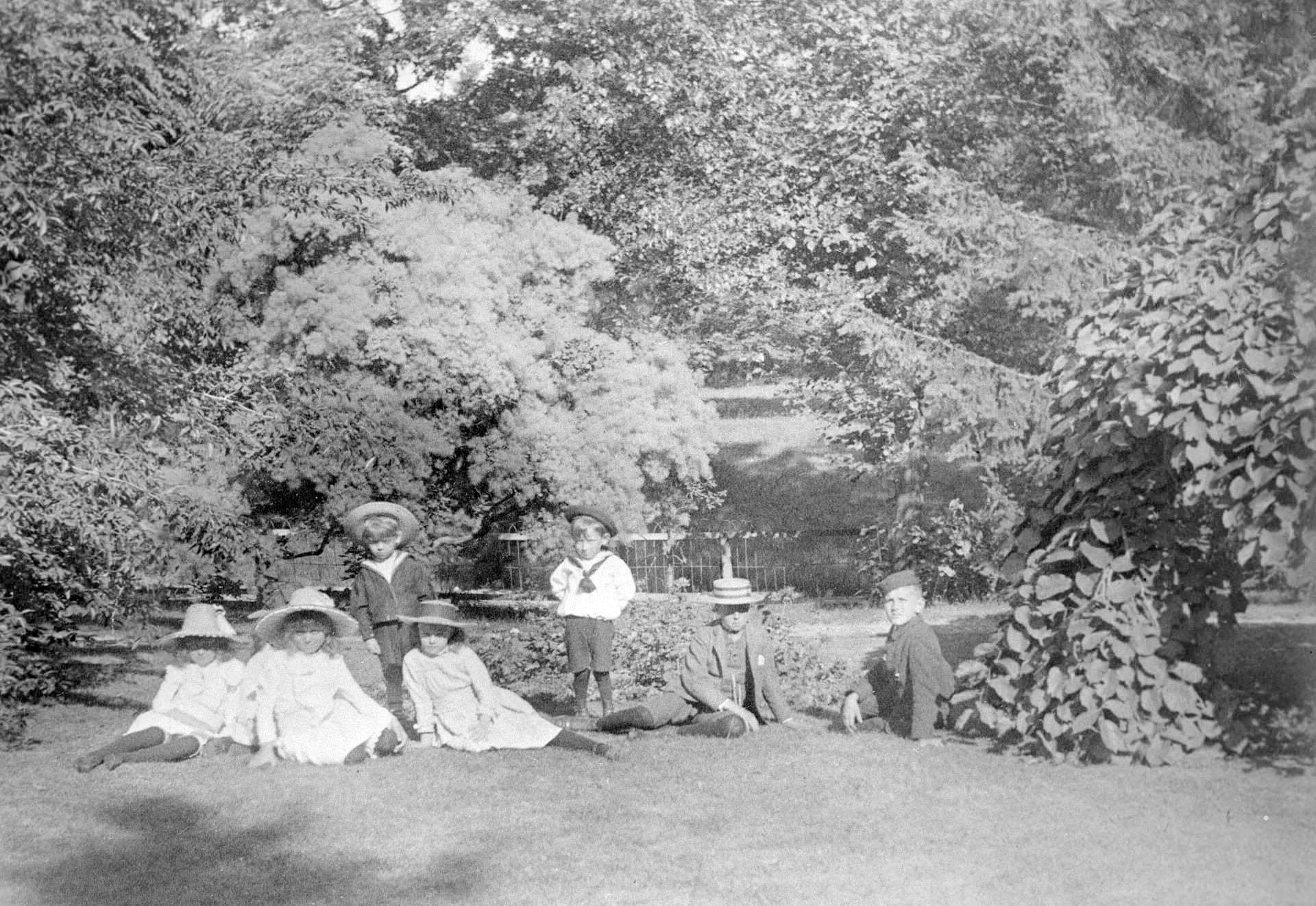 Children lounging in the yard. Beatty, William H., house, Queen's Park Cres. W., north of College Street, 1900.