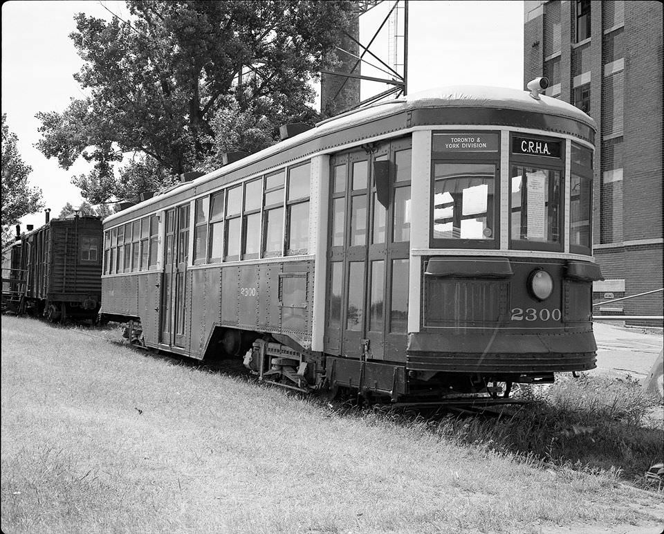 This Peter Witt used to sit next to (east of) the building at 545 Lakeshore Boulevard. The sign on the window indicates that car 2300 was the first one built for the TTC in 1921 and was retired in 1963, the same year that the Canadian Railroad Historical Association acquired the car.