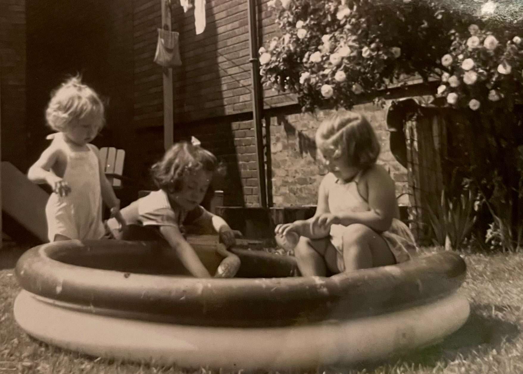 Playing in the backyard pool, 1950s