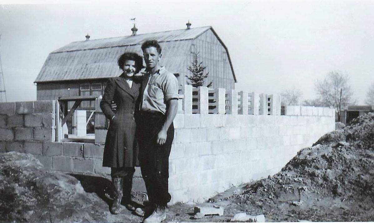 A couple in front of the house they were building on Pharmacy Ave just south of Lawrence Ave, 1960s