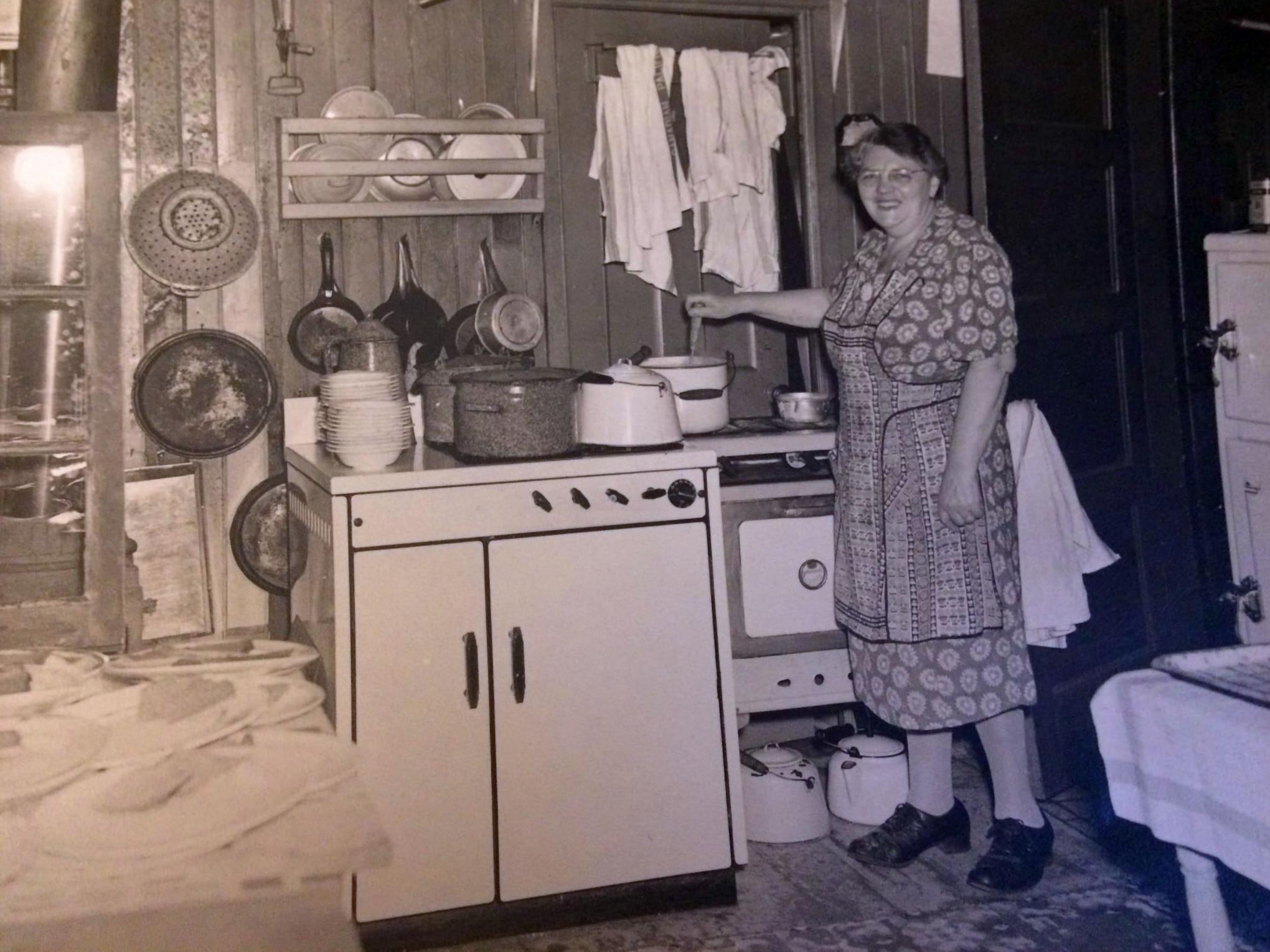 A woman in her kitchen on Toronto Island around the 1940