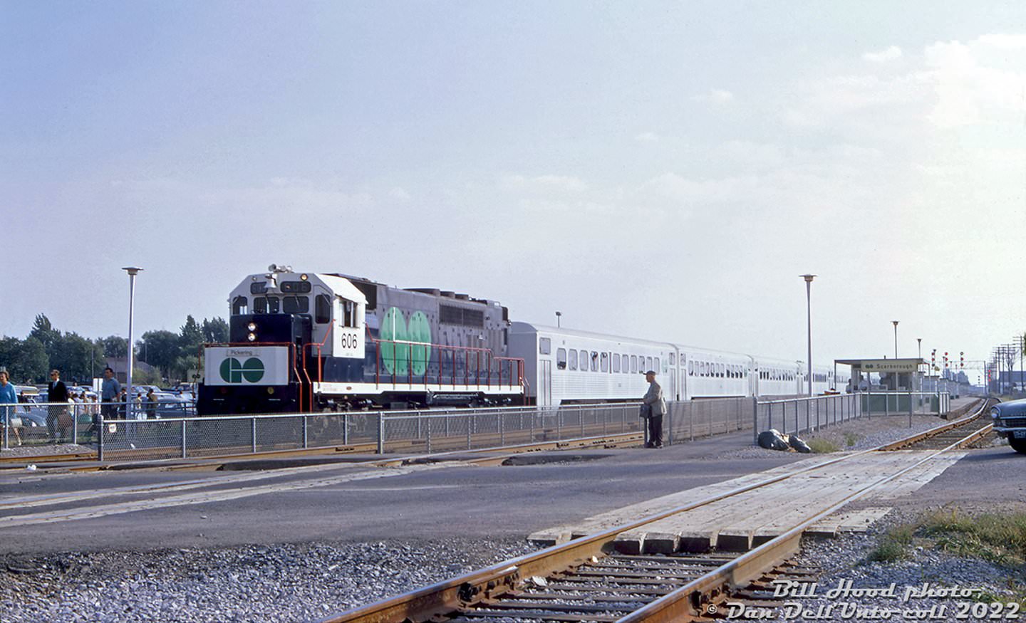 GO locomotive GP40TC #606 heads an eastbound train out of Scarborough GO station about to cross the busy St. Clair Ave. E. grade crossing in September of 1967, during the first few months of GO train operation.