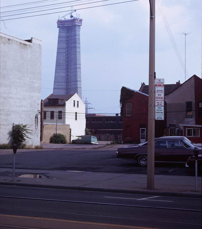 CN Tower - construction view from King West and Widmer, view looks south past houses on Mercer St., 1974