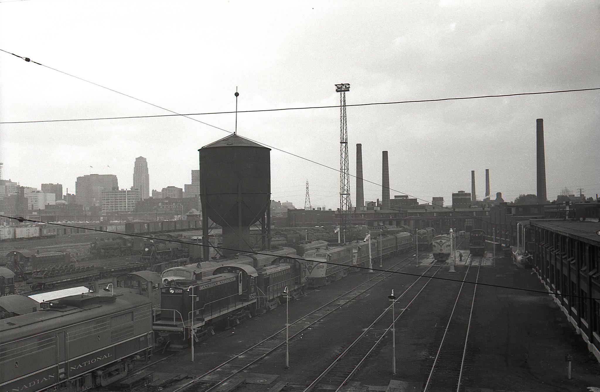 Looking east from Spadina Avenue, right at the Spadina Roundhouse. Many locomotives, 1960s.