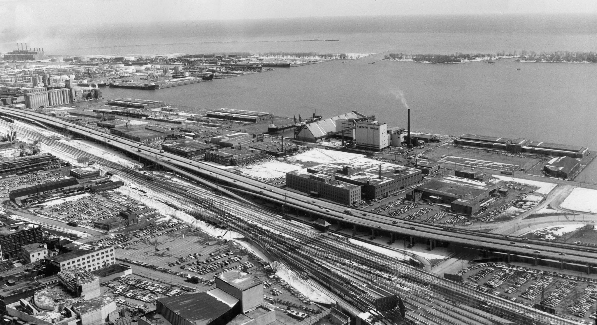A view southeast, picking up marine terminals, the Redpath Sugar plant, and the broader commercial port, 1960s