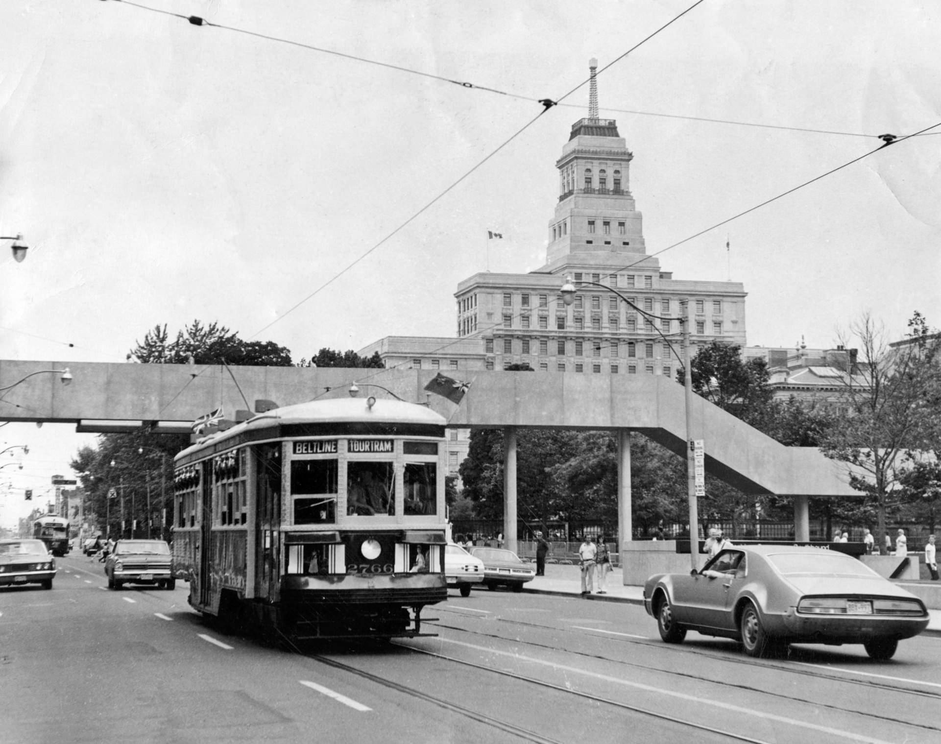 Tour Tram trips. TTC Streetcar 2766 heads east on Queen near Bay, July 1973.