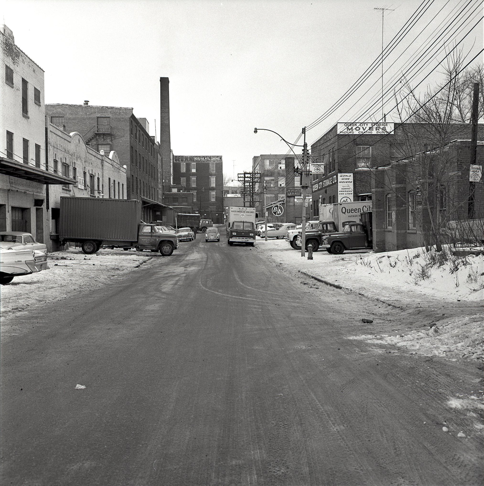 A mid-town industrial streetscape that no longer exists. Looking west along Pears Ave. toward Bedford Rd., 1964.
