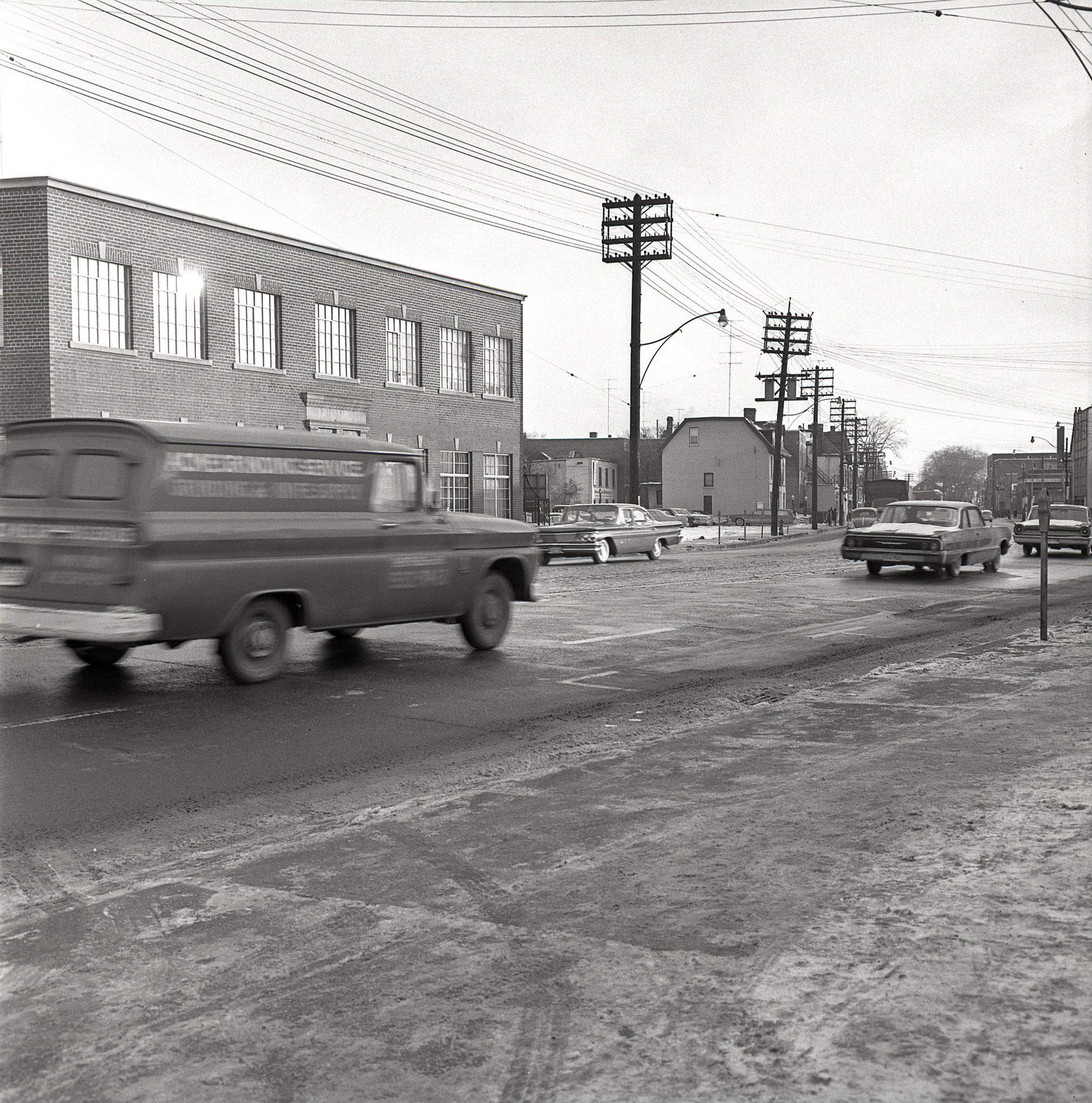 Looking east along Davenport Rd., towards Avenue Rd., 1964. For context, if you zoom in, that metal fire escape in the distance still exists, and is on the side of the building that is now Avenue Diner at 222 Davenport. The diner was 'Avenue Coffee Shops' in 1964