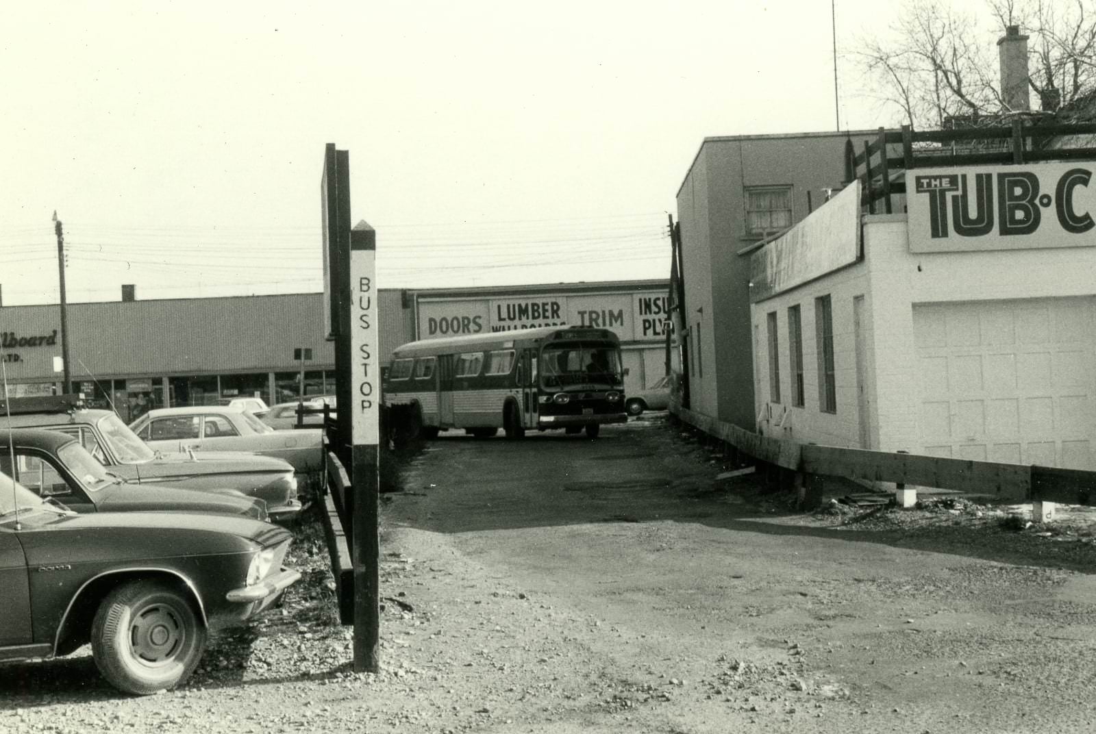 Dawes bus coming west through laneway from dawes to Loblaws parking lot loop, 1960s