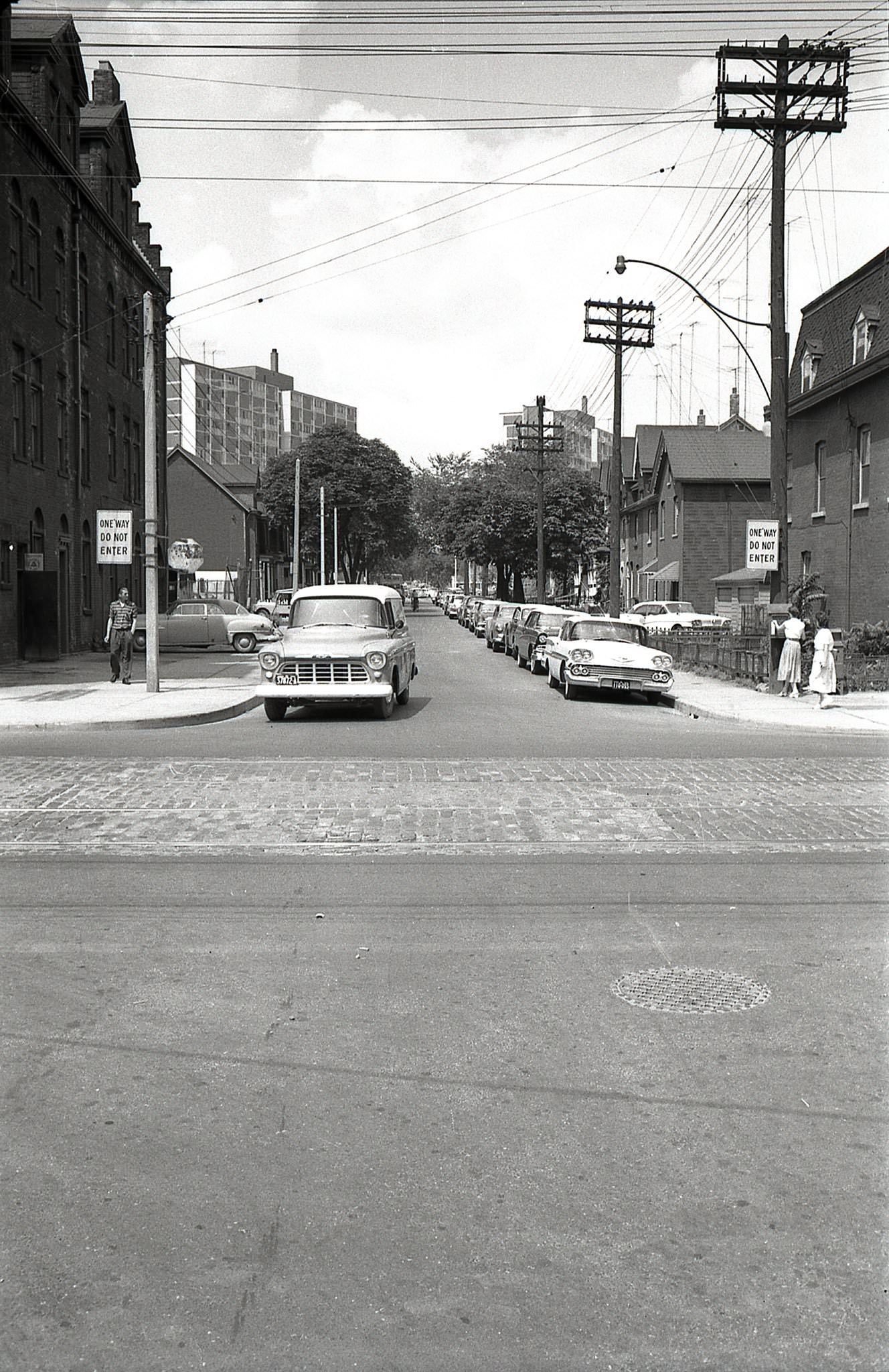 Looking north along Sumach Street from Queen, 1960s. In the distance, two of Peter Dickinson’s Maisonette Towers are visible.