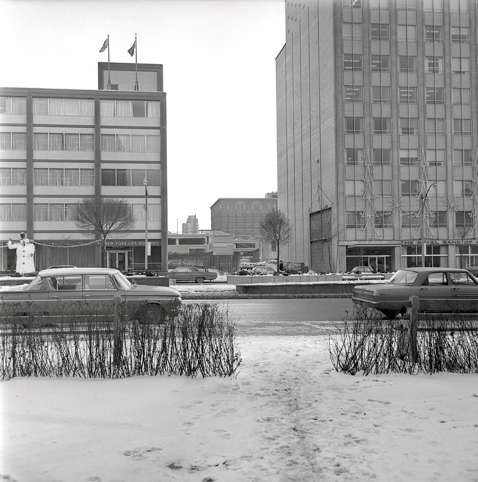 The gap between the buildings is 439 University Ave (east side of the street, south of Dundas), 1964.