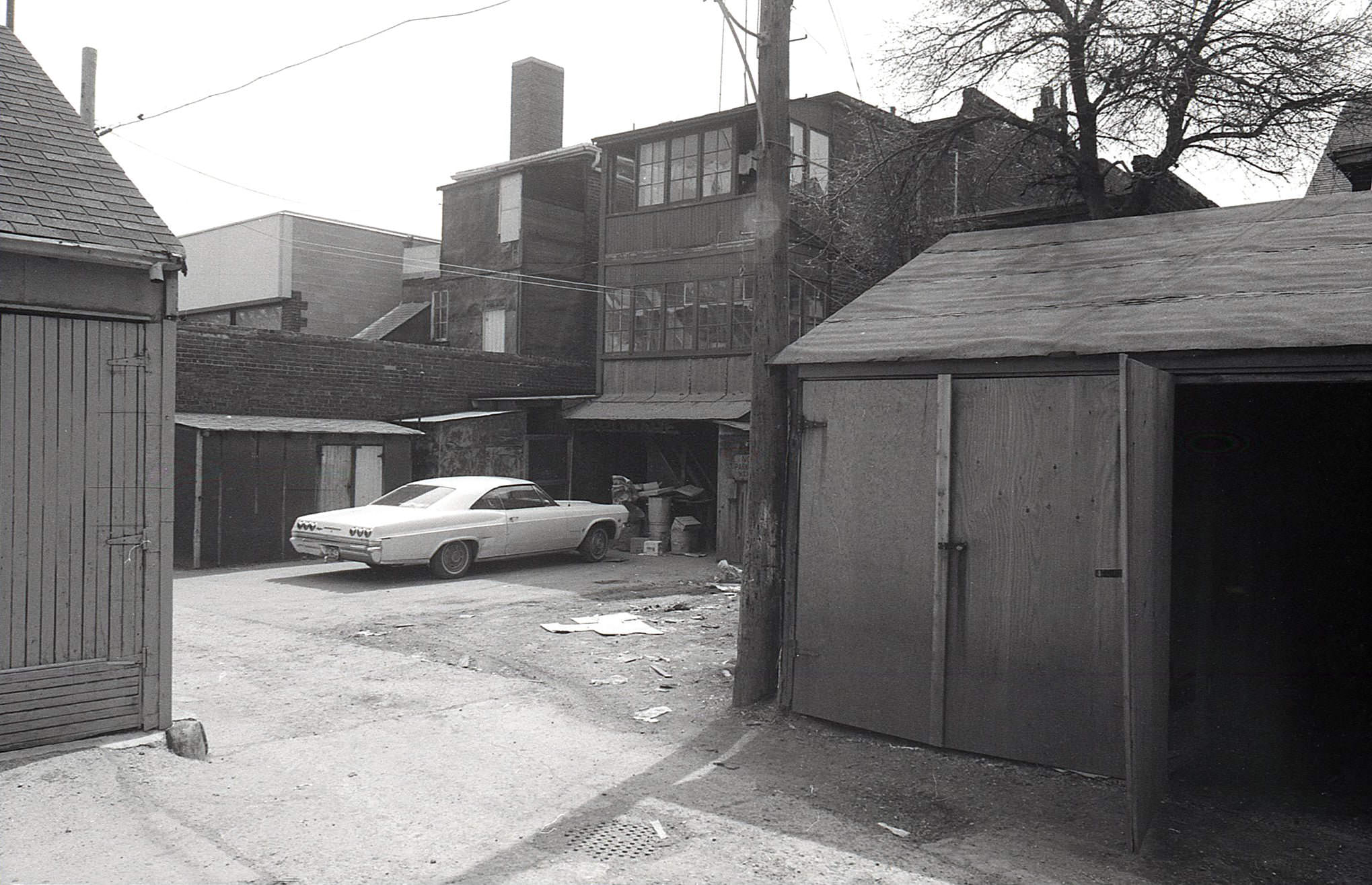 The laneway behind 500-514 Danforth Ave., April, 1969. View looking southeast - a little of the Danforth/Ferrier BMO branch peeking out towards the left.