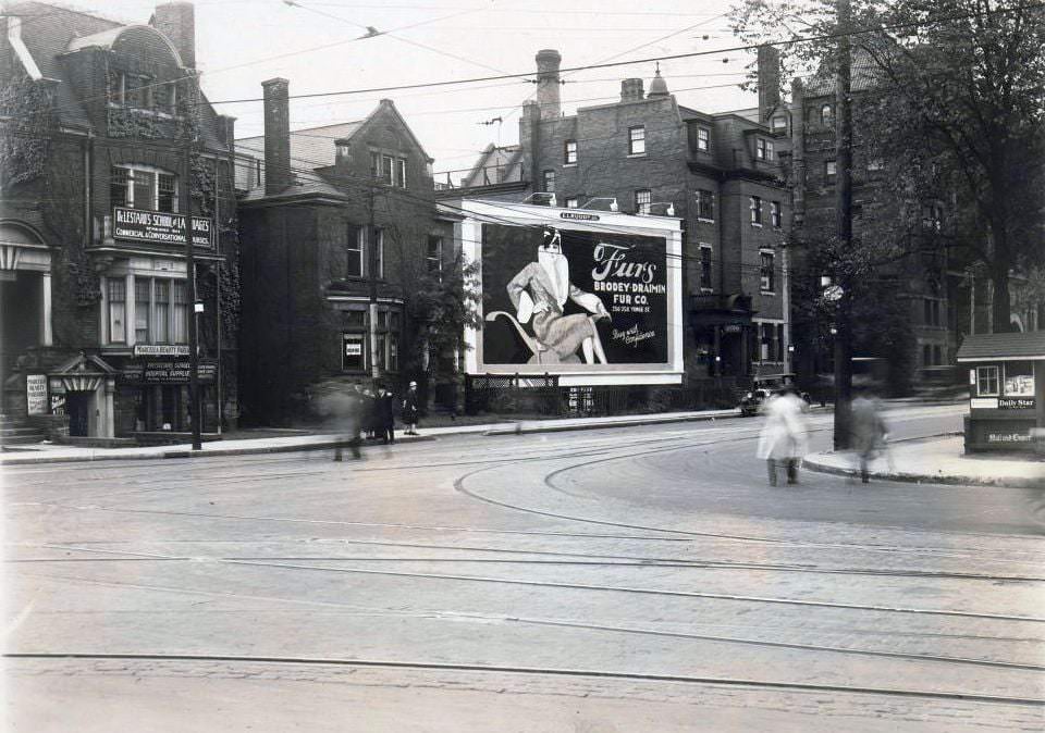 South side of College Street, near Bay Street. Visible in the image is the De Lestard's School of Languages, 53 College Street, and Marcella Beauty Parlour and Physicians & Surgeons Hospital Supplies, 1920s