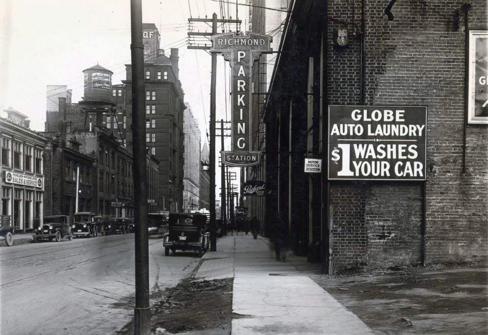 Richmond Parking Station. An electric overhanging sign on a building located on the south side of Richmond Street West, west of Bay Street. View is looking east, 1920s