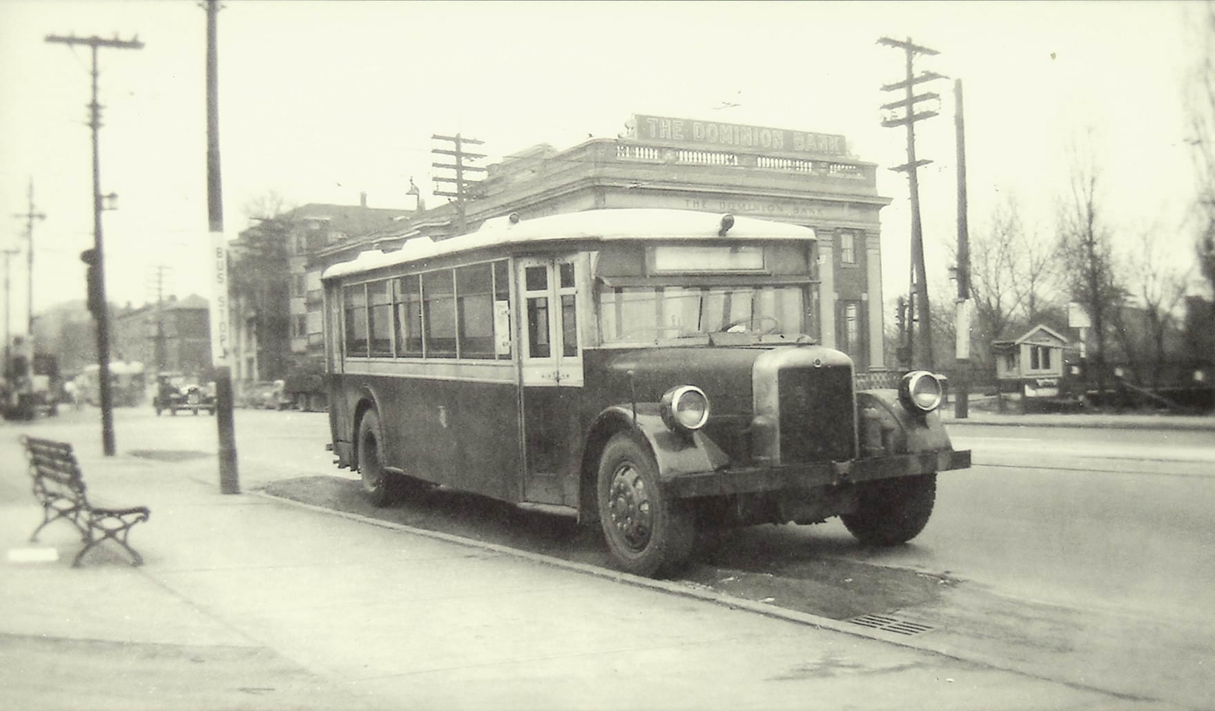 A TTC bus parked on the south side of Bloor St. E., view looking northwest to Sherbourne St., 1945.