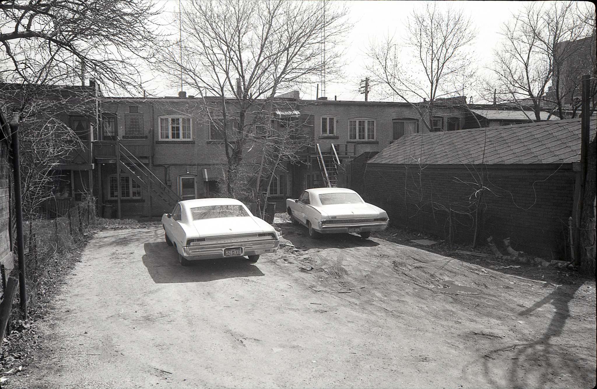 Two cars are parked behind 3340/3342 Yonge Street (north of Fairlawn), 1969