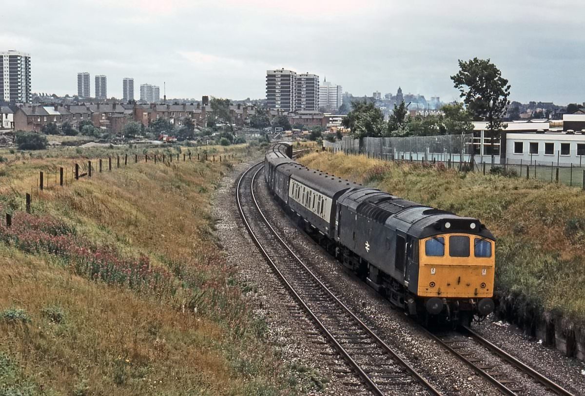 BR Sulzer Type 2 No. 25135 heads a down parcels train north of Ryecroft Junction on 14th August 1979.
