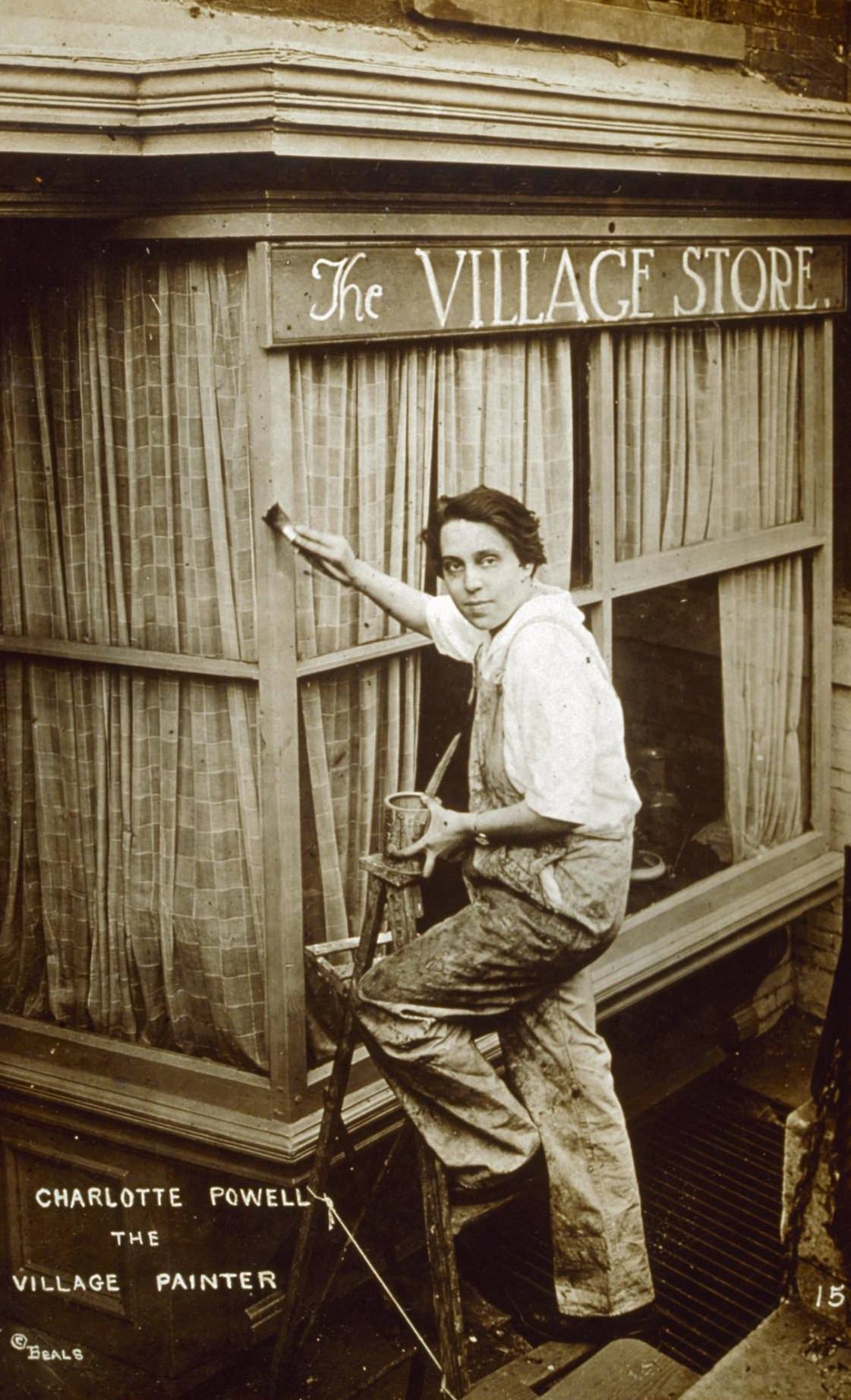 Portrait of Charlotte Powell standing on a ladder and painting the exterior of The Village Store, Sheridan Square, 1926