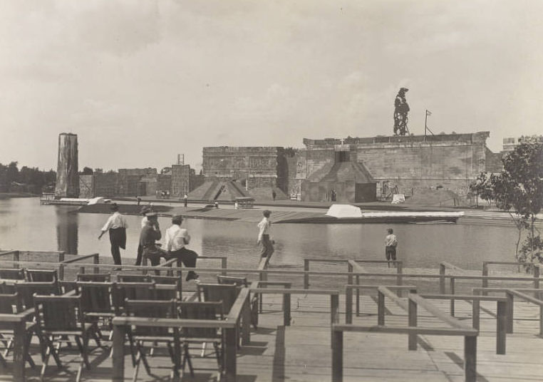 Passers-by look over workers building the set for the Pageant and Masque of St. Louis, 1914