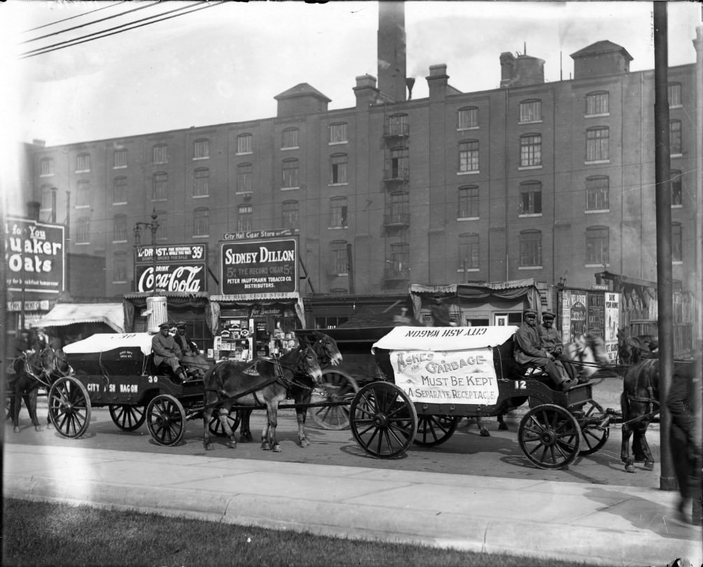 Parade of St. Louis city ash wagons. Small businesses are visible in the background, 1910