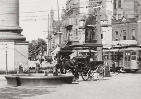 A delivery horse enjoying a drink from a water trough at the North Grand Circle, 1910