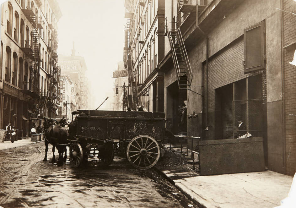 A team of horses delivering a wagon full of coal for the Ice Fuel Co. to a business on St. Charles Street, 1910