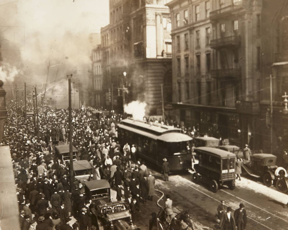 A large group of onlookers watching firefighters battle a fire near the intersection of St. Charles Street and Broadway downtown, 1913