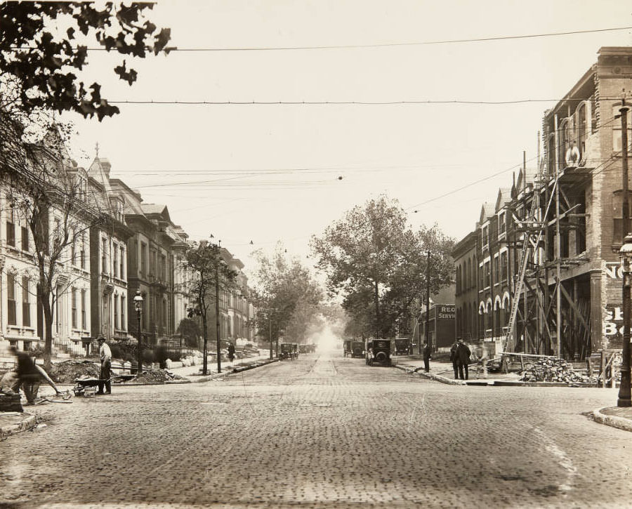 Street and building repair work being done on Washington, just east of its intersection with Channing Avenue in Midtown, 1915