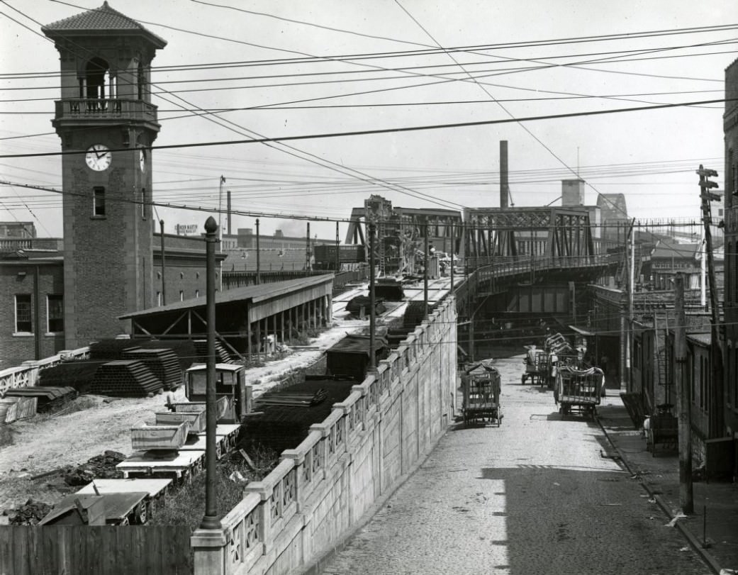 Elevated roadway above 6th Street with streetcar tracks in process of being laid, approach to Free Bridge (now MacArthur Bridge). The elevated rail bed is to the left.