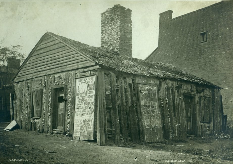 A one-story log structure. The front is labeled Old Courthouse, 1870.