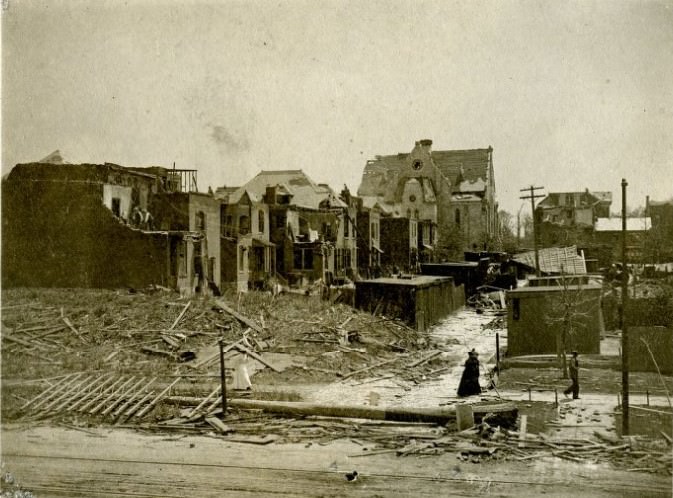 An elevated view of an alley, as well as several destroyed buildings, residential properties, and a church in a St. Louis neighborhood after a tornado hit on May 27, 1896.