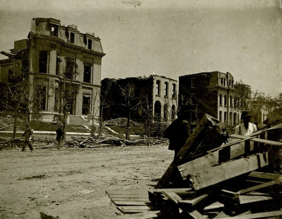 Street view of destroyed buildings, debris and bystanders in the aftermath of a tornado which hit St. Louis' Lafayette Square neighborhood, 1896