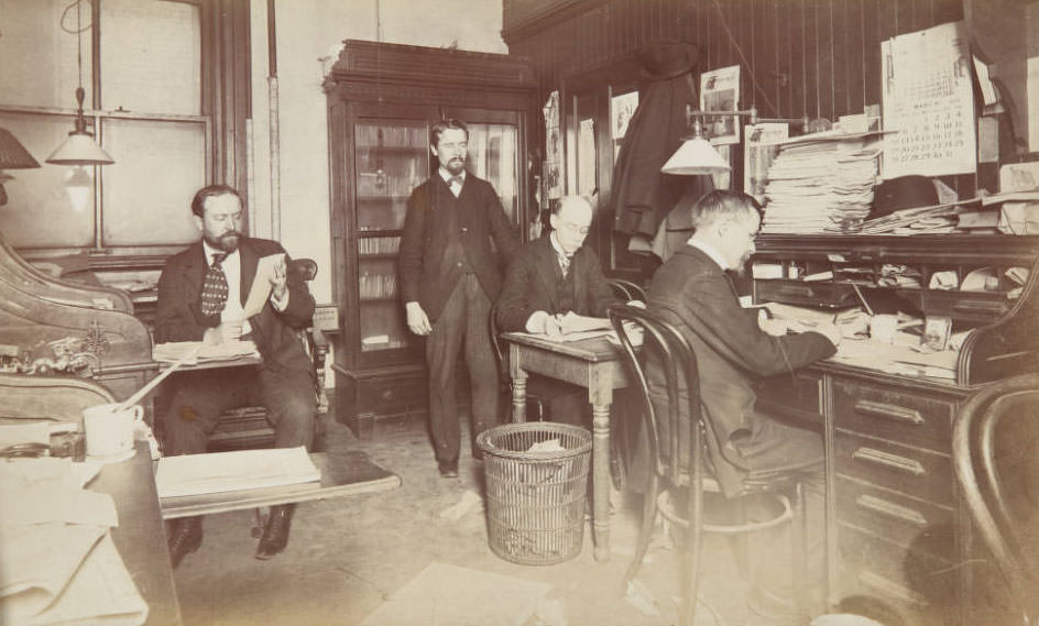 Four Post-Dispatch men working in office, 1899