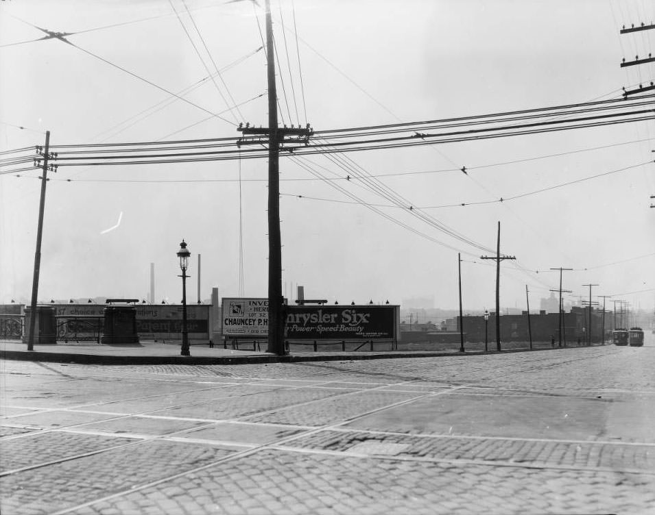View of billboards and streetcars looking west down Market Street at the intersection with Grand Ave., 1925