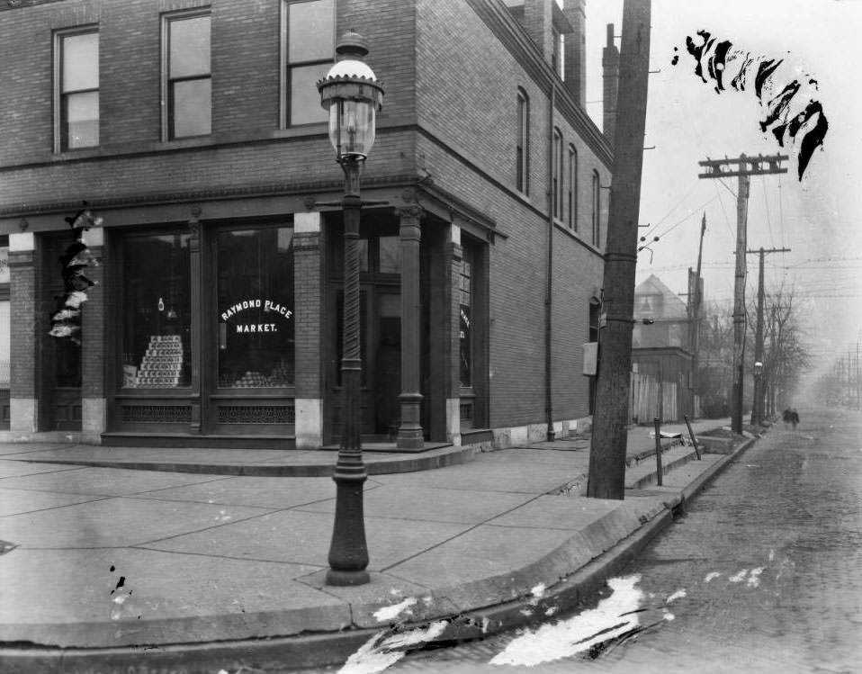 View south down Academy Ave., showing the Raymond Place Market at the southeast corner of Page Blvd. and Academy Ave, 1925