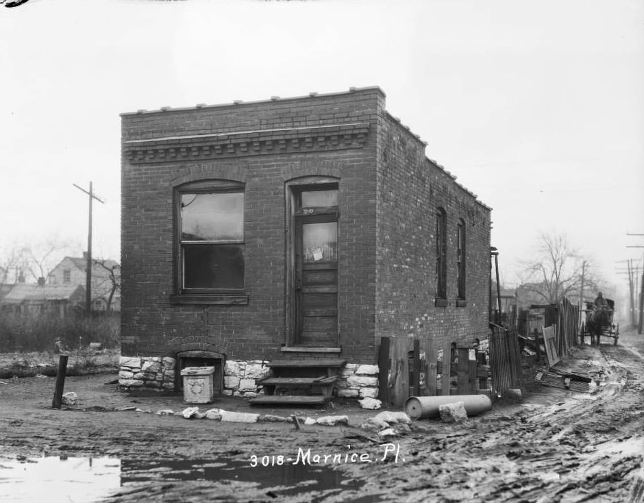 View of a one-story brick dwelling next to a muddy lane in the Ville neighborhood, 1925