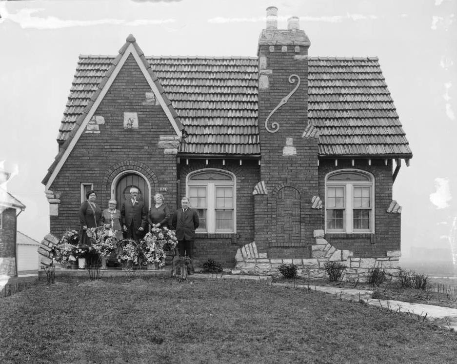 View of a group of five people - three women and two men - standing at the door in front of 6324 Mardel, 1925