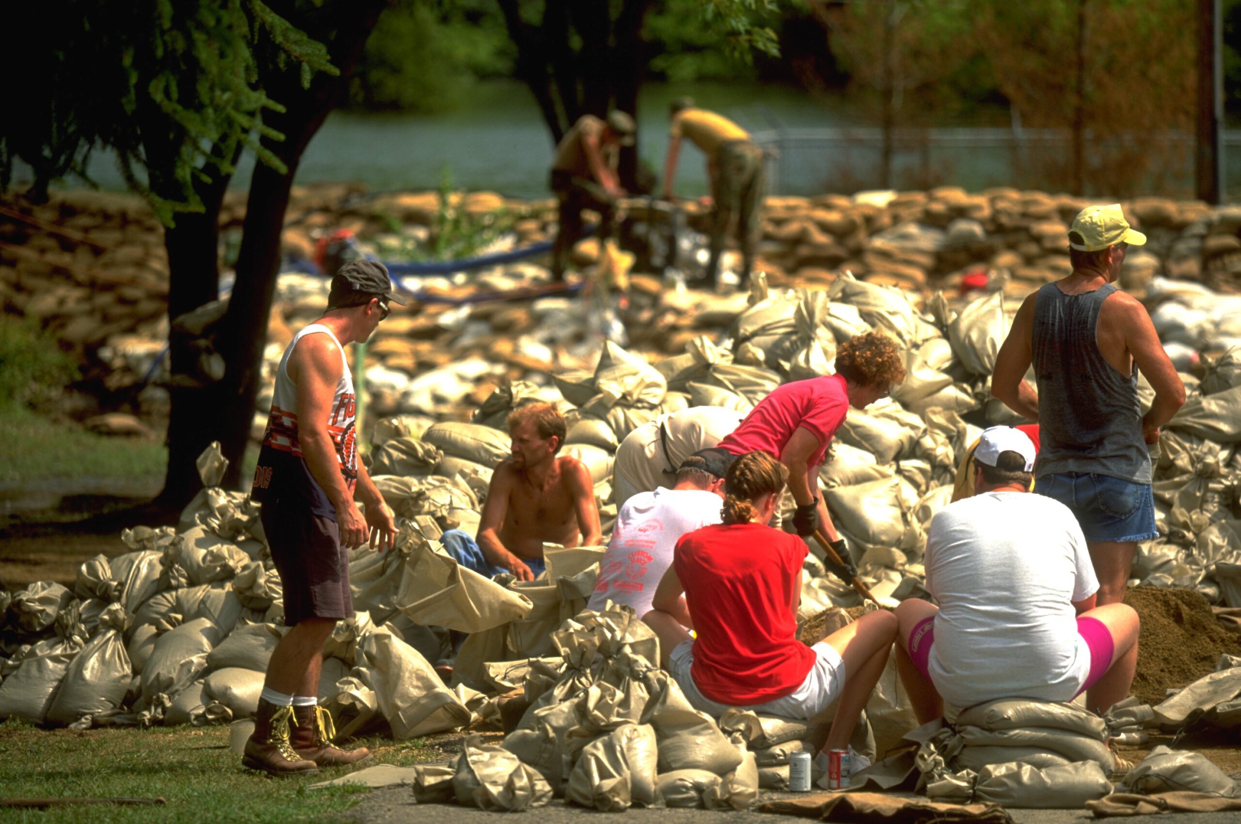 Residents and volunteers work to fill sandbags in an effort to stop the flood from causing further damage, 1993