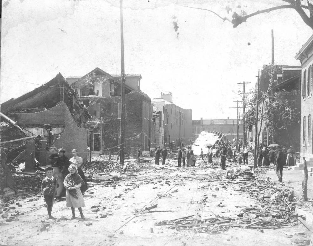 This view looking south on 8th Street from Rutger Street shows people wandering through the rubble. The De La Vergne Refrigerating Machine Company on Park Avenue can be seen in the distance.