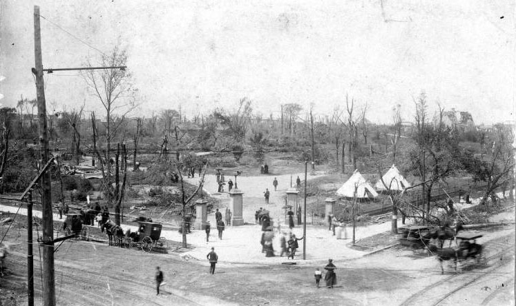 People come and go through the northeast entrance to Lafayette Park, taking in the destruction.