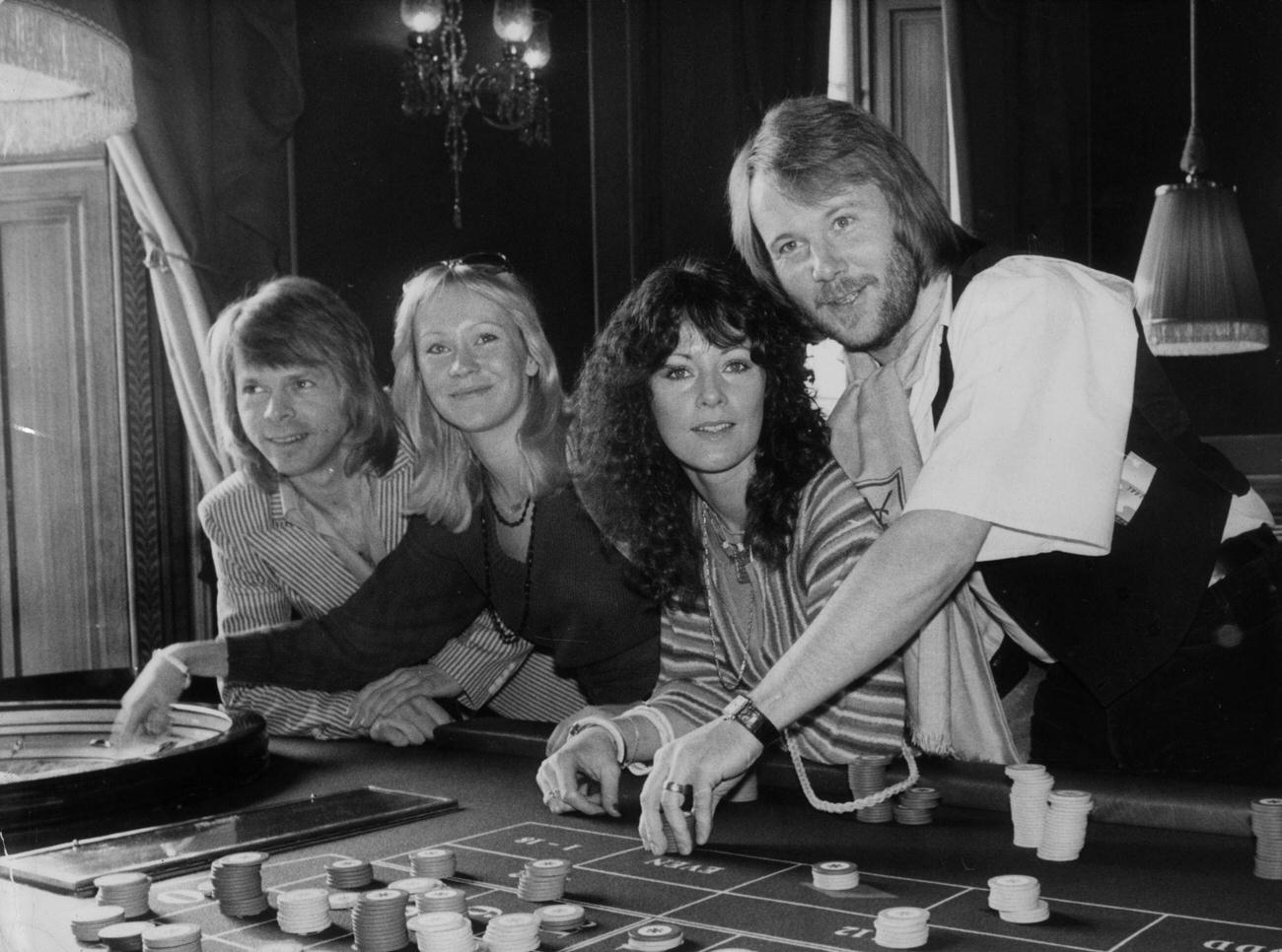 ABBA try their luck at a Crockford's roulette table whilst attending the premiere of their latest film 'ABBA - The Movie' in London.