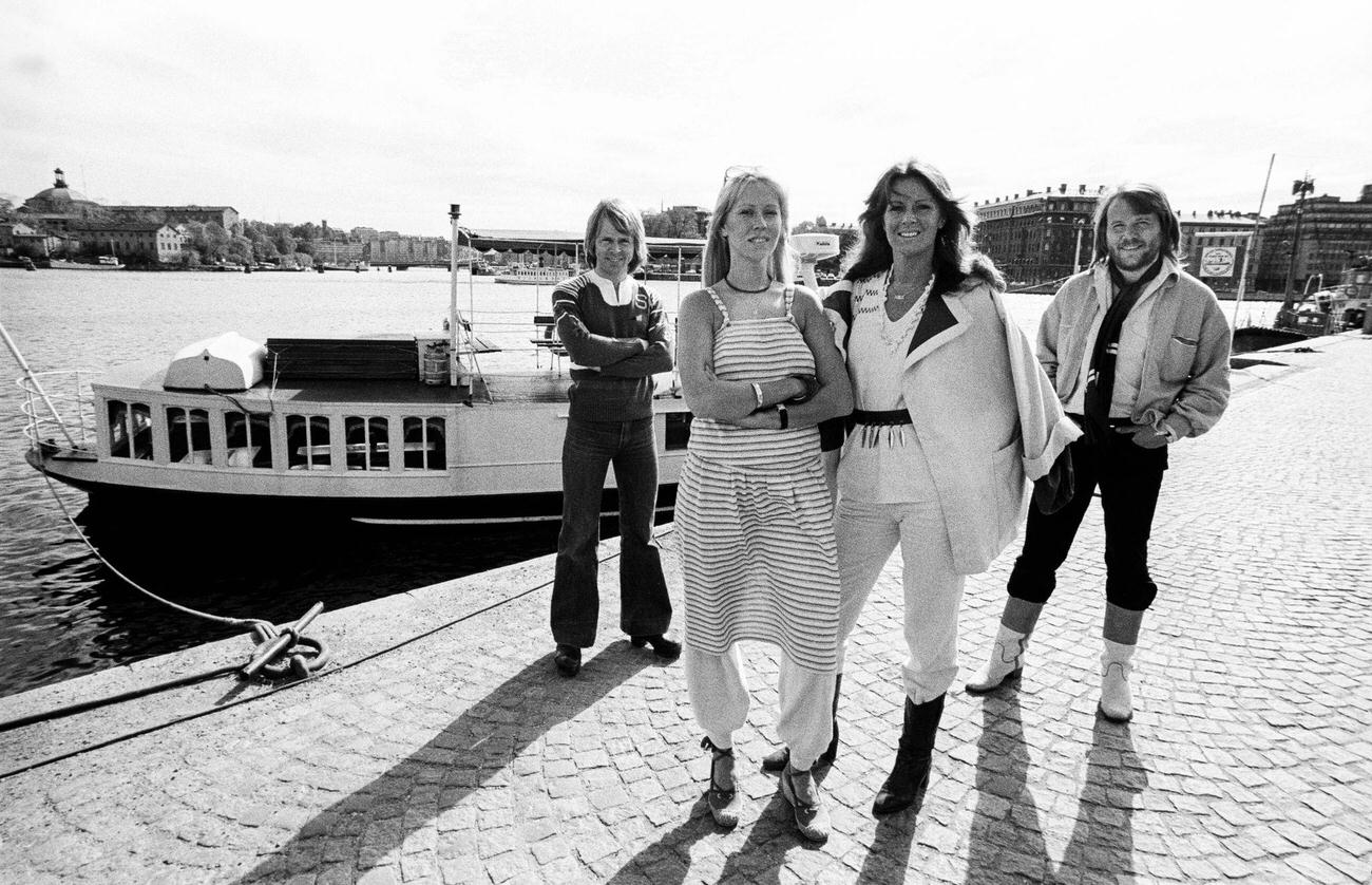 ABBA group posing dockside, in Gamla Stan (Old Town), Stockholm, Sweden, July 1977.